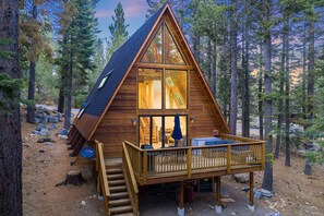 A wooden cabin with a balcony, a staircase, and a view of the surrounding forest. - Sleeps 20, 2 Homes Near Ski Resort | Beach + Lake Access, Pool | Homewood (Tahoma)