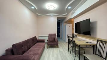 Standard Apartment, Balcony | Living area | 50-inch flat-screen TV with cable channels