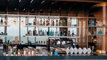 A bar area with shelves of bottles, glasses, and bar equipment.