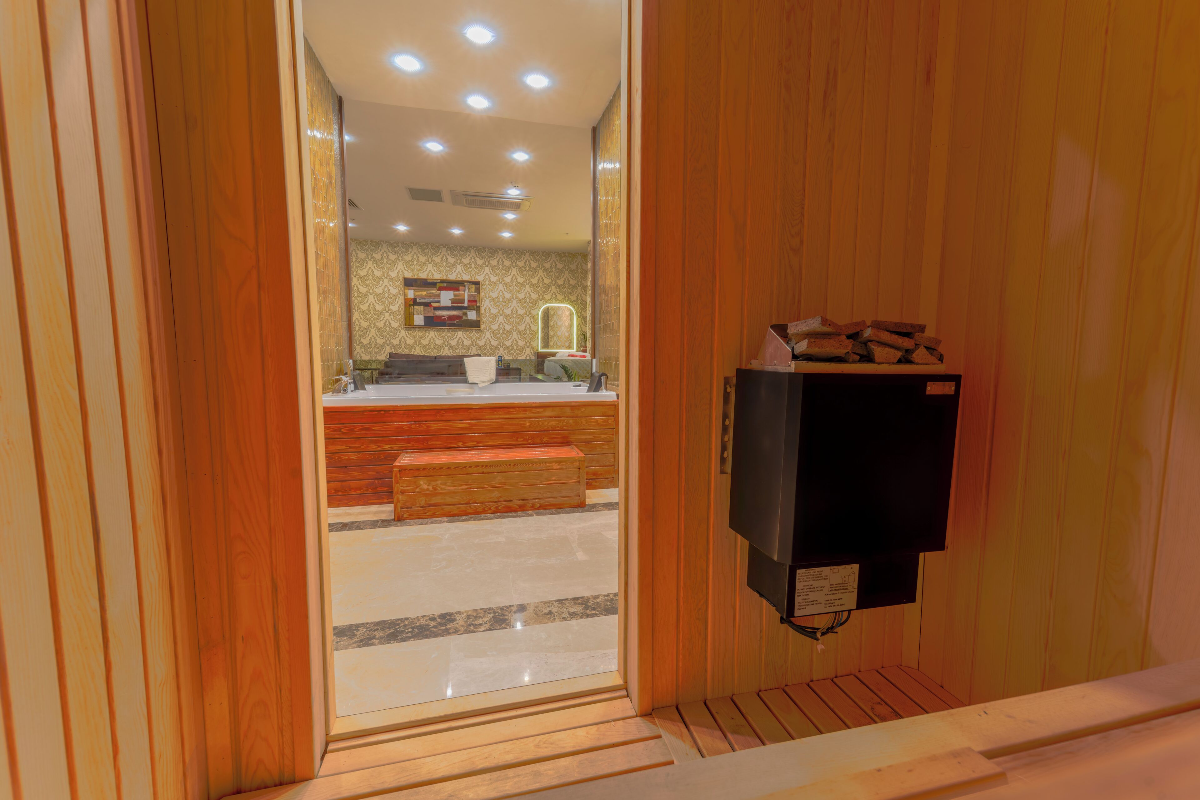 A wooden interior with a bench, a counter, and a wall-mounted TV.