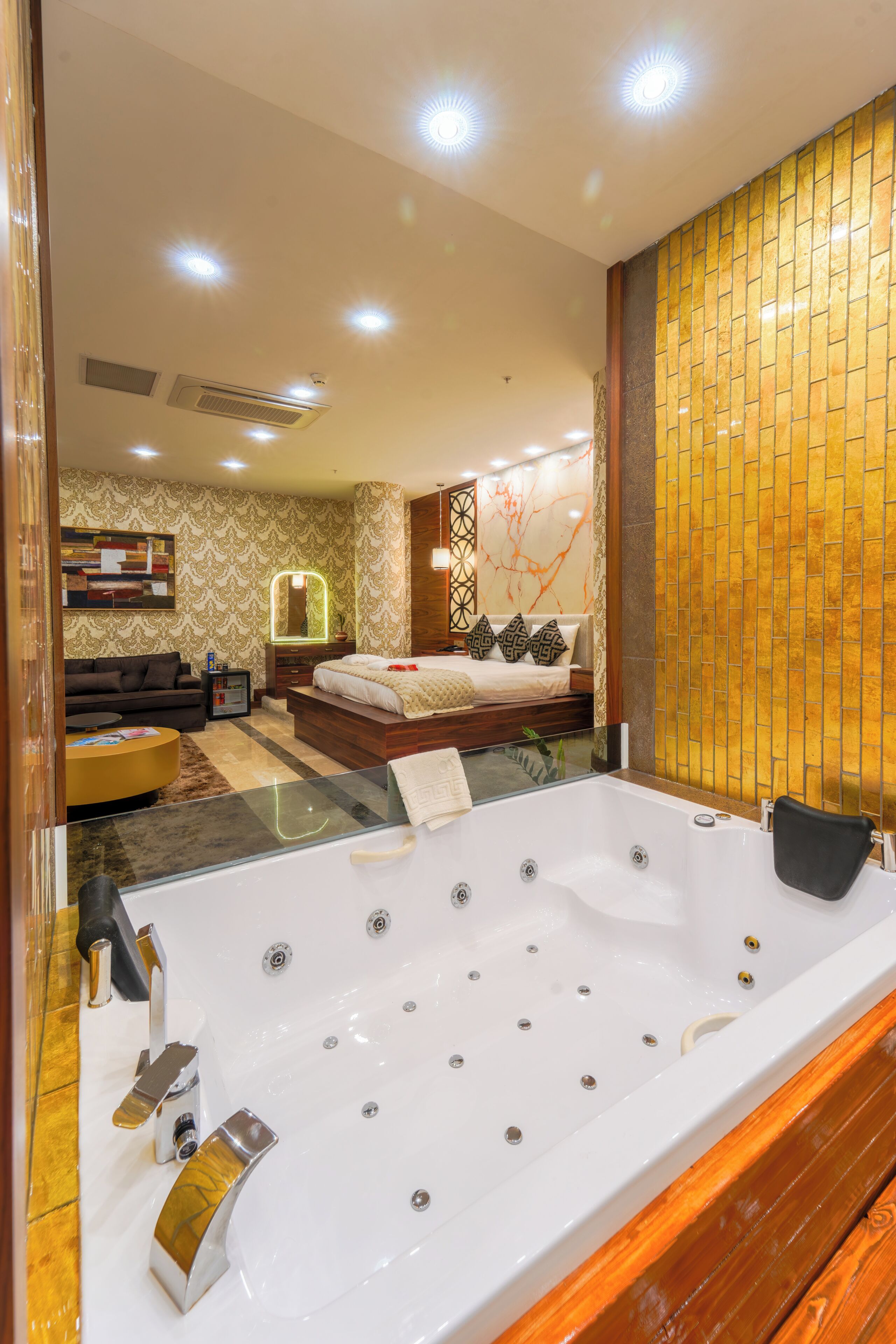 A modern bathroom with a large bathtub, a wooden vanity, and a mirror.
