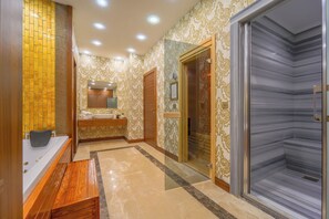 A modern bathroom with a bathtub, vanity, and a shower enclosure. - Grand Canyon Hotel (Ankara)