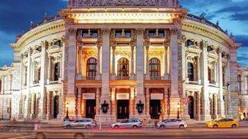 A large, classical building with multiple columns and arched windows.