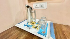 A bathroom sink with a faucet, a mirror above it, and a power outlet on the wall.