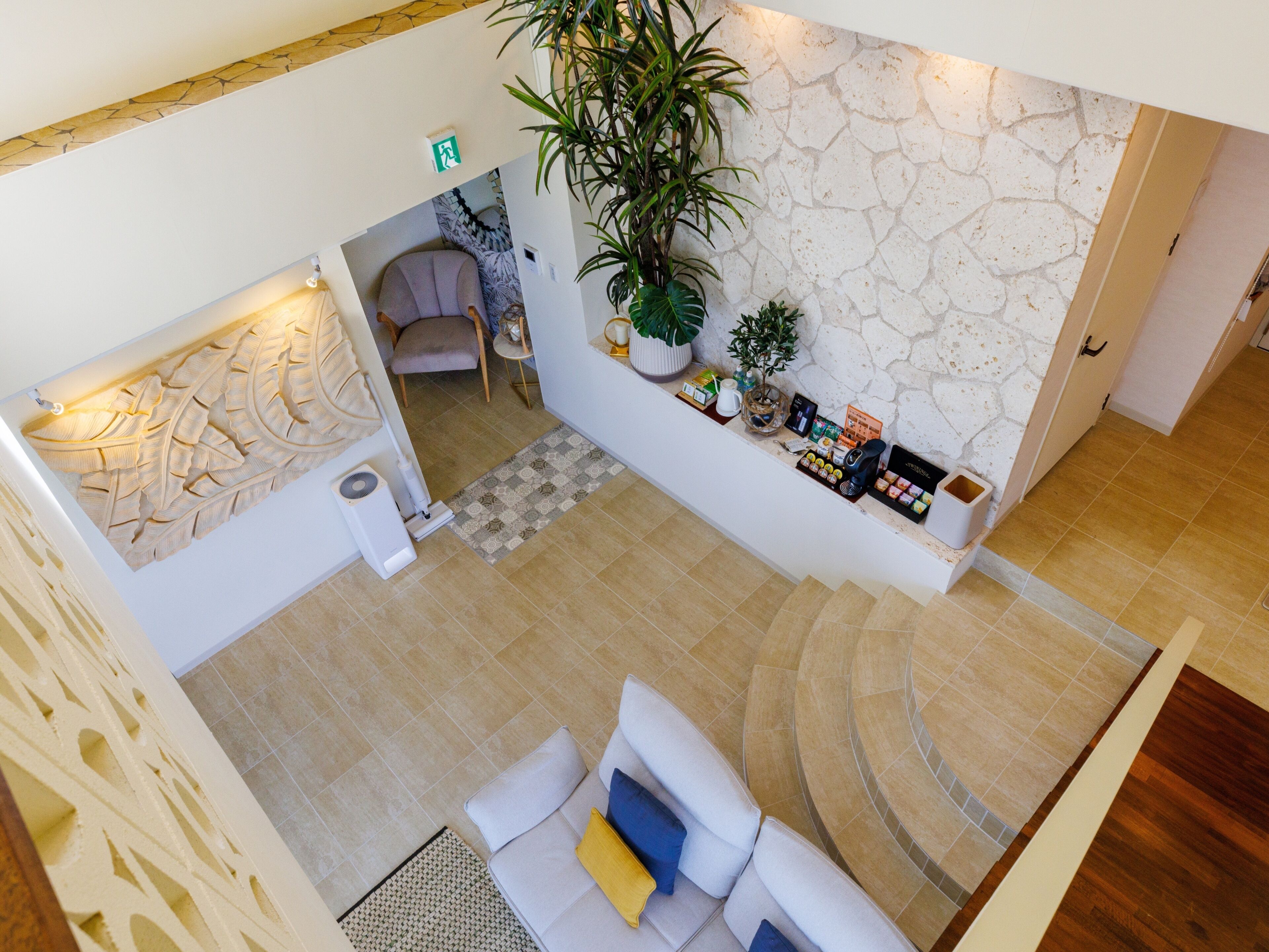 A spacious lobby with a seating area, a reception desk, and a decorative wall.