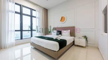 A modern bedroom with a large bed, a bedside table with a plant, and a view through large windows.