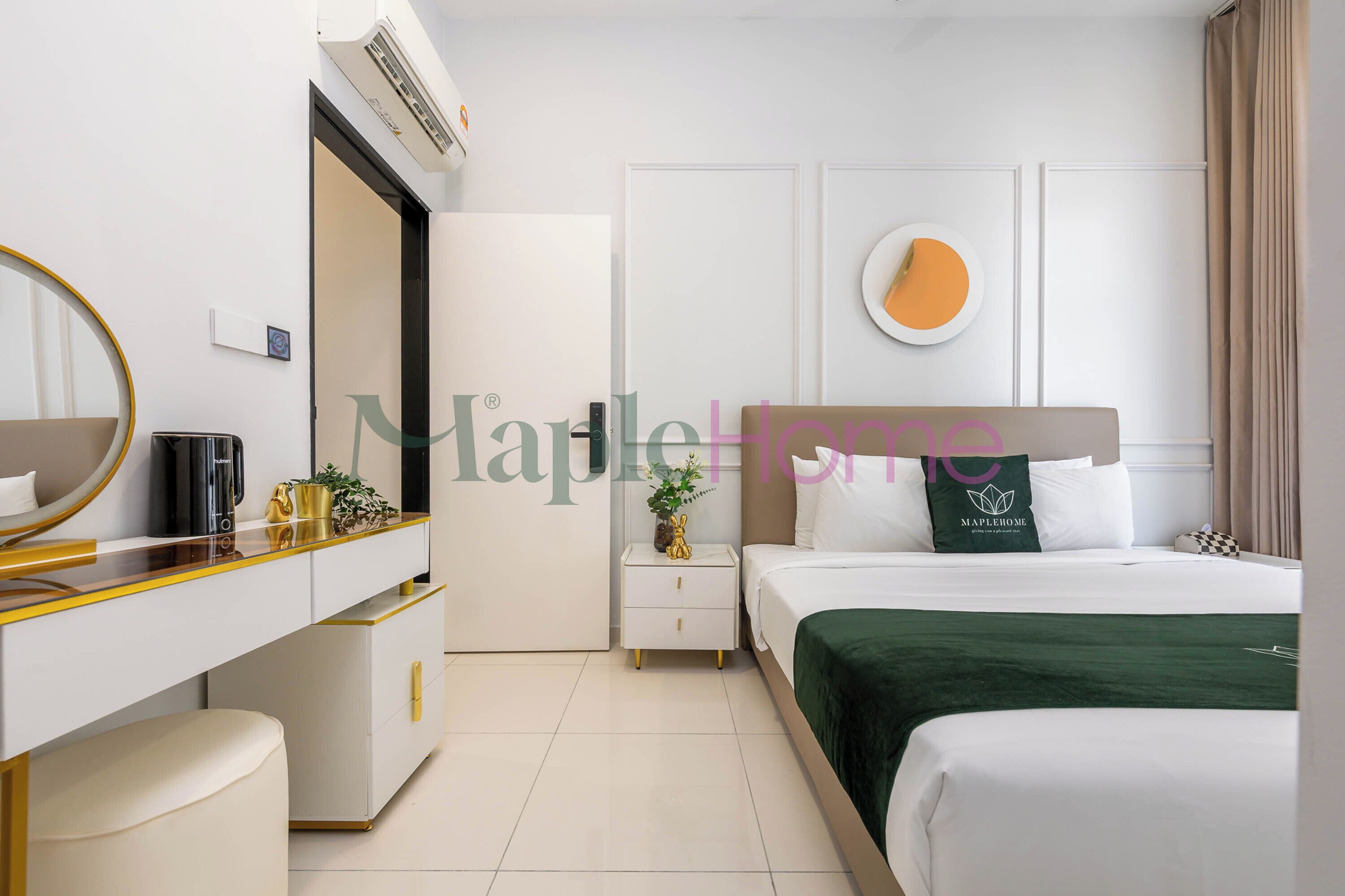 A hotel room with a bed, a bedside table, a mirror, a dresser, and a wall-mounted air conditioner.