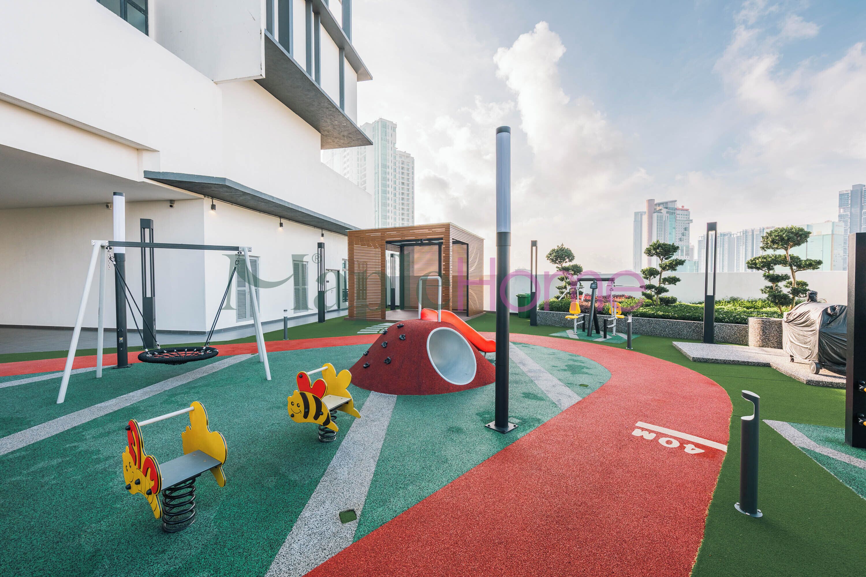 A children's play area with swings, a slide, and a climbing structure.