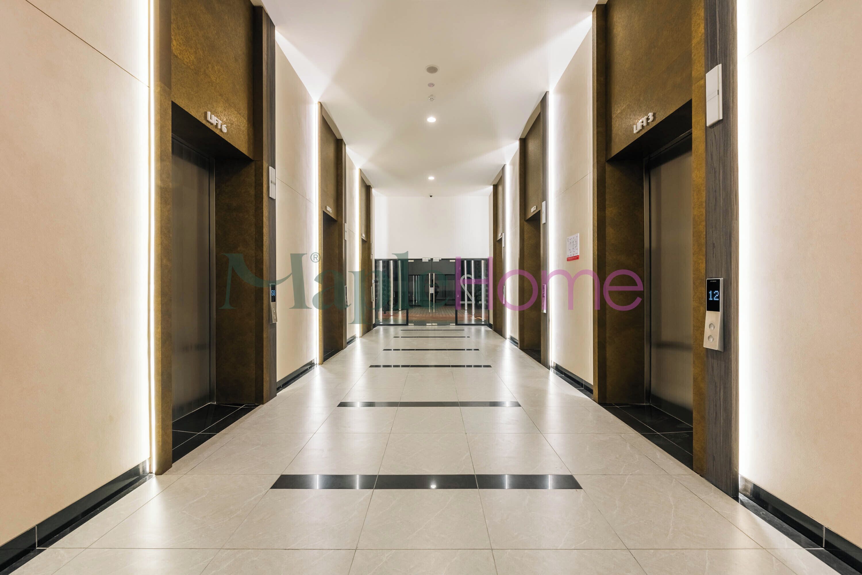 A long, narrow hallway with a tiled floor and walls, flanked by elevators and doors.