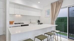 Dishwasher, coffee/tea maker, cookware/dishes/utensils, dining tables