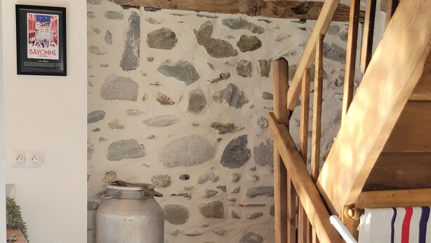 A staircase with wooden railings and stone walls.