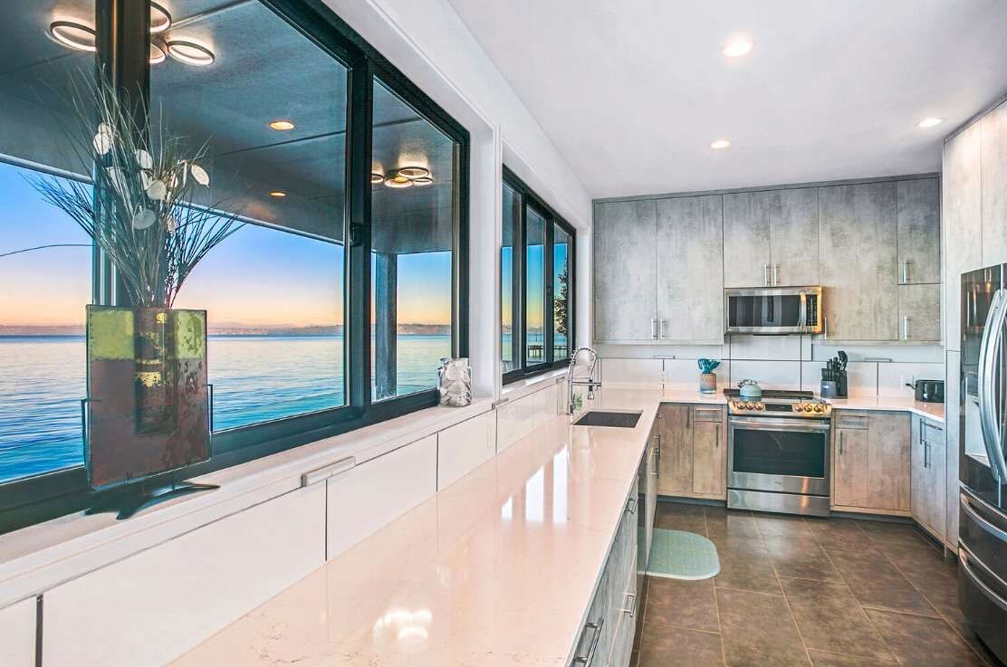 Savor the art of coastal cooking in a kitchen framed by sweeping ocean views.