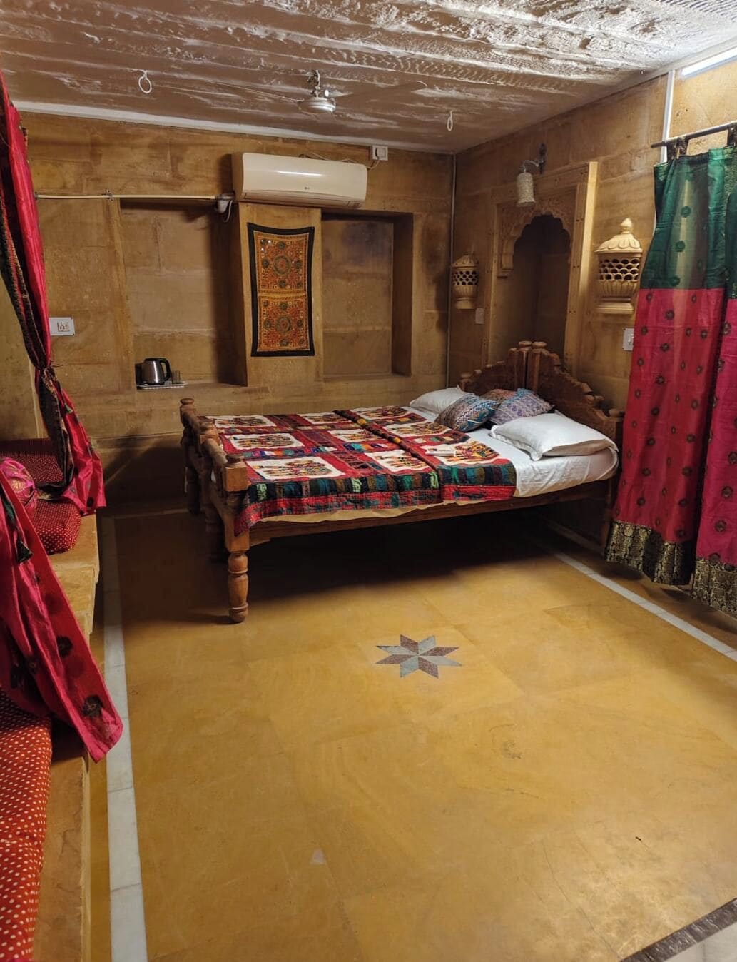 A room with a wooden bed, a wall-mounted air conditioner, and a patterned rug.