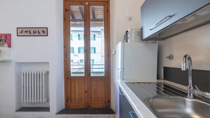 A modern kitchen with a double door, a built-in sink, and a radiator. - Vanna's House near the center of Florence (Firenze)