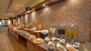 A buffet with various food items and drink dispensers. - Belvilla Marina View Suites, Dubai Marina (Dubai)