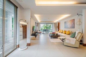 Deluxe Apartment (3 Bedrooms) | Living area | 32-inch TV with cable channels - Elegant Beachfront 3BR Condo at Pearl of Naithon (Sa Khu)