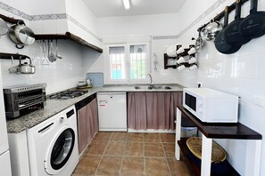 Een koelkast, een magnetron, een kookplaat, een vaatwasser