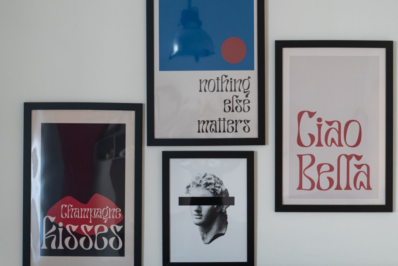 Four framed artworks on a wall.