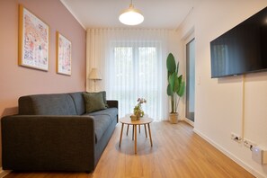 Departamento Deluxe, 1 habitación, balcón | Área de sala de estar