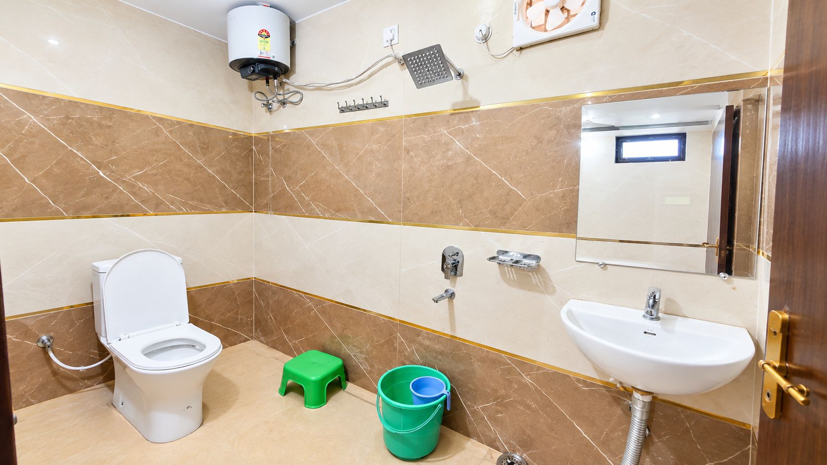 A bathroom with a toilet, sink, and shower.