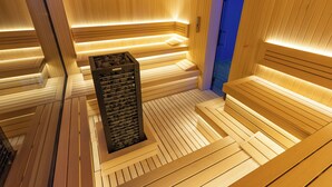 A sauna with wooden benches and a central heating unit. - Aris KOP Kopaonik (Raška)