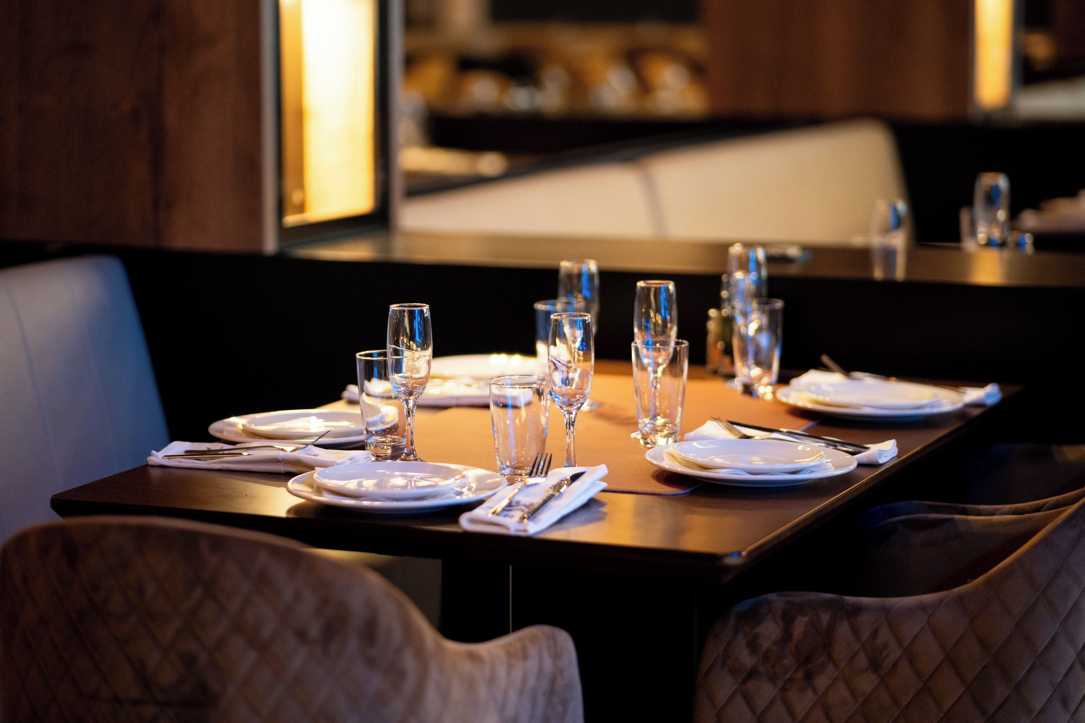 A restaurant table set with plates, glasses, and cutlery.