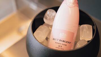 A bottle of Brut Dargent Pinot Noir Ice in a bowl with ice cubes.