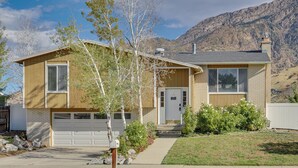 A two-story house with a garage, a front porch, and a mountain backdrop. - Big Space, Bigger View! Cottonwood Canyon Retreat (Salt Lake City)