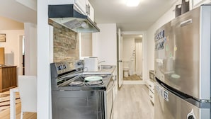 A modern kitchen with a stainless steel refrigerator, a built-in oven, and a stove. - < 2 Mi to Umass Health & Dtwn: Traveling Pros Hub (Worcester)