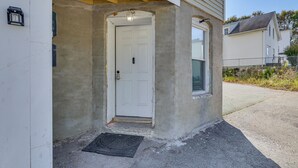 A white door with a small window above it, a concrete porch, and a metal doormat. - < 2 Mi to Umass Health & Dtwn: Traveling Pros Hub (Worcester)