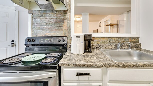 A kitchen with a gas stove, a coffee maker, and a sink. - < 2 Mi to Umass Health & Dtwn: Traveling Pros Hub (Worcester)