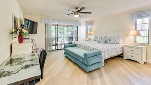 A bedroom with a bed, a desk, a chair, a ceiling fan, and a window with curtains. - 4 Mi to Siesta Beach: Condo w/ Community Perks! (Sarasota)