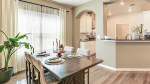 A dining area with a wooden table, chairs, and a potted plant. - 11 Mi to Texas Tech University: Cozy Family Home! (Wolfforth)