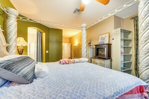 A bedroom with a large bed, a dresser, a vanity, and a bookshelf. - Near Golf Courses & Casinos: Maricopa Home w/ Yard (Maricopa)