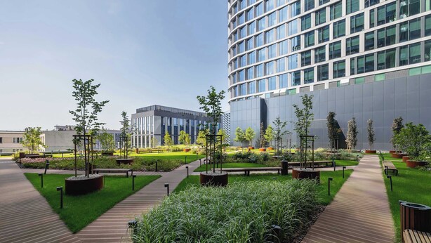 A modern urban plaza with a central pathway, surrounded by greenery and benches. - Stylish Studio in the Center of Katowice | Balcony | Parking (Katowice)