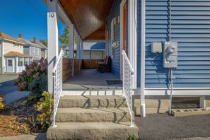 A residential house with a covered porch, a front door, and a mailbox. - 3BR Apt Center of Bar Harbor! [Blueberry Bungalow] (Bar Harbor)