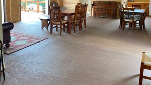 A spacious room with a high ceiling, wooden walls, and a large dining table with chairs. - Where the stars are brighter, the nights are quieter, and the Smokies feel alive (Sevierville)