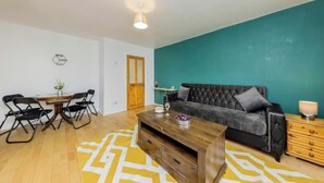 Una sala moderna con sofá, mesa de centro y comedor.