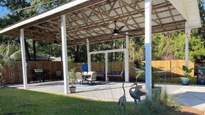 A covered patio with a grill, seating area, and a hammock. - The Cardinal House 1A. In a Stunning area, see the deer pass by! (Savannah)
