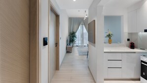 A modern kitchen with white cabinets, a built-in oven, and a countertop. - Elegant 1BR Stay in Binghatti Heights (Dubai)