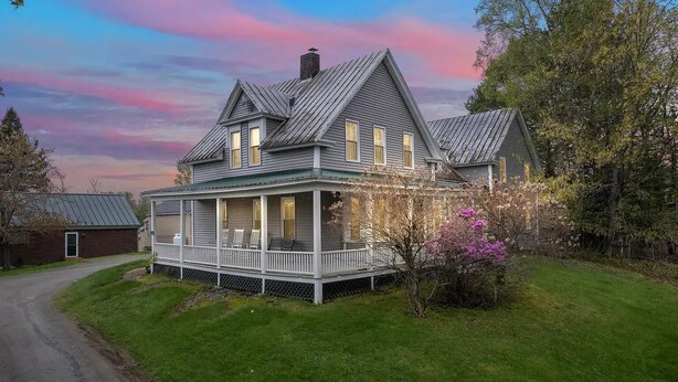 A large, two-story house with a porch and a chimney. - Welcoming 5-bedroom farmhouse in Rangeley (Rangeley)