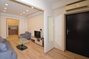 Family Apartment | Living area | 50-inch flat-screen TV with cable channels