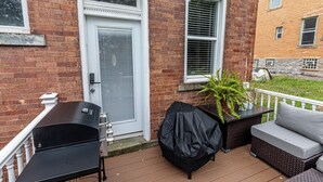 A deck with a grill, outdoor seating, and a potted plant. - Spacious Modern 7BR Retreat ~ 3 Story Gem in Pittsburgh (Pittsburgh)