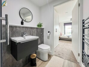 Shower, hair dryer, towels, toilet paper