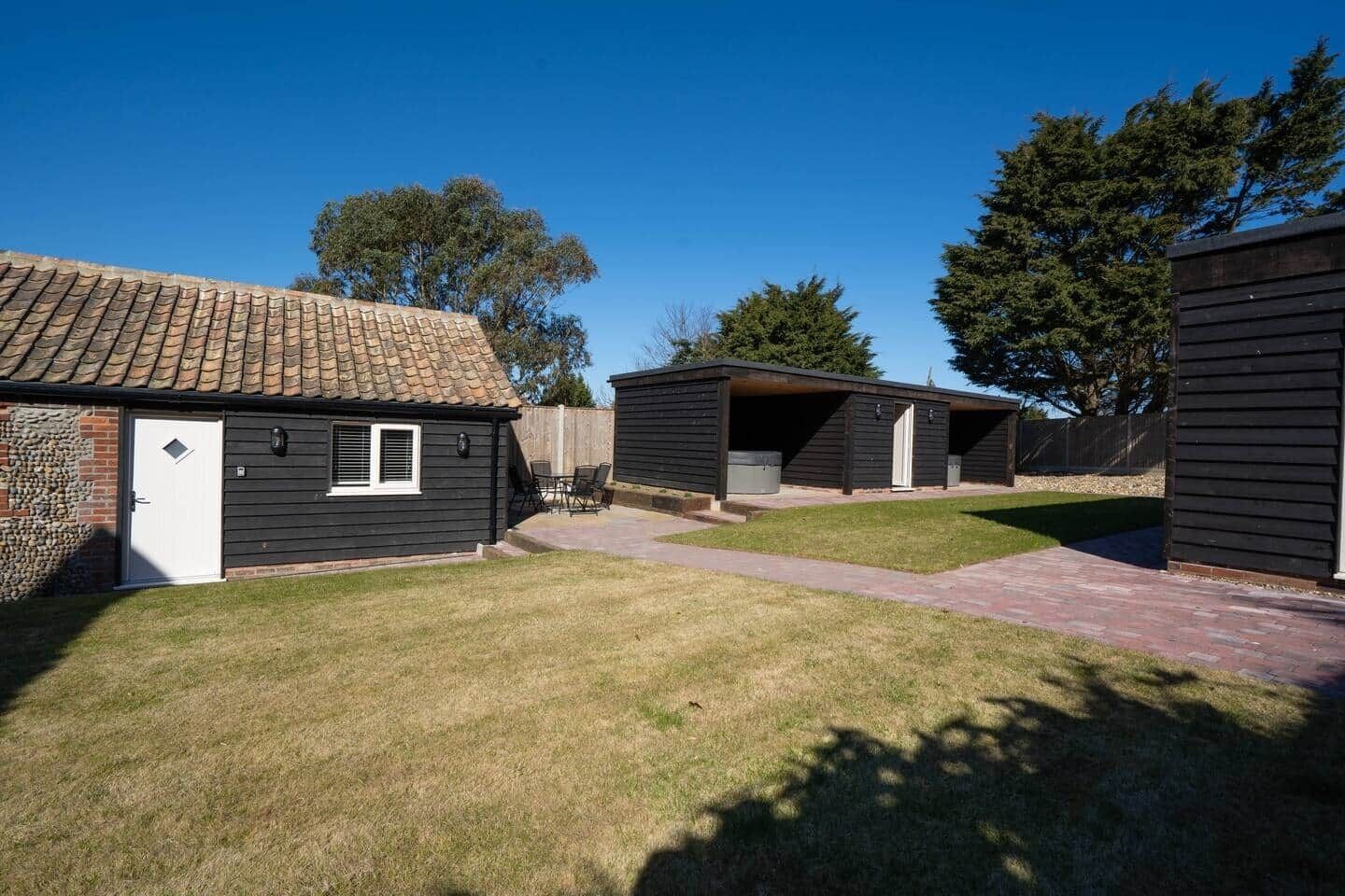A residential area with a house featuring a tiled roof and a garage.