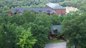 A large lodge with multiple buildings surrounded by dense forest. - Westgate Branson Woods NYE 2Bedroom Villa. (Branson)