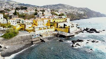 Beach nearby, black sand, sun loungers, beach umbrellas
