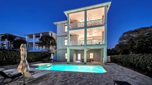A multi-story building with a swimming pool, outdoor seating, and a balcony. - ☀️Stunning Private Pool | Golf Cart | 30A | Topsail (Santa Rosa Beach)