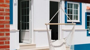 A white building with blue trim and a red roof. - Zulla Nazaré Surf Village  (Nazaré)