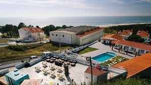 A rooftop with a swimming pool, a covered area with seating, and a view of the ocean. - Zulla Nazaré Surf Village  (Nazaré)